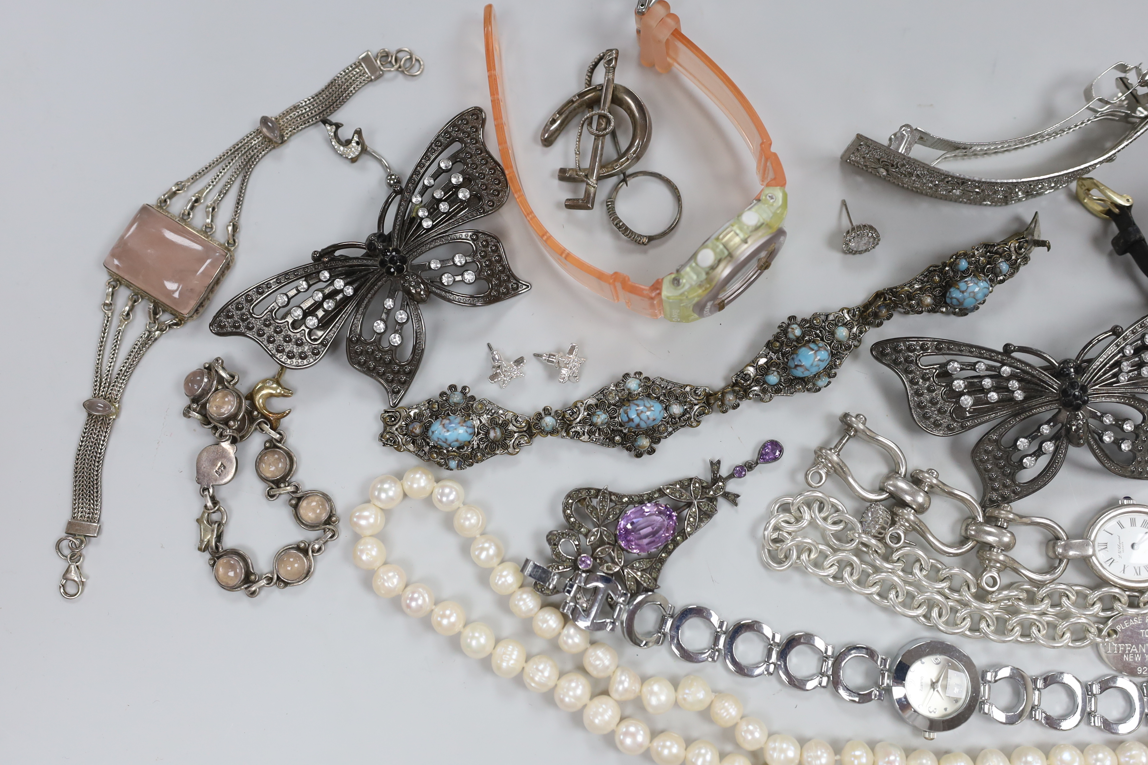 Four assorted 9ct gold and gem set rings, gross weight 6.3 grams, a 925 and rose quartz bracelet, a silver bracelet watch, a silver horseshoe and riding crop brooch and other jewellery including costume.